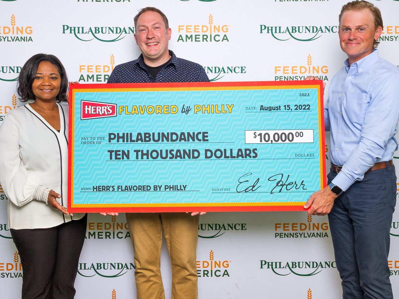 Herr's Flavored by Philly winner holding their check