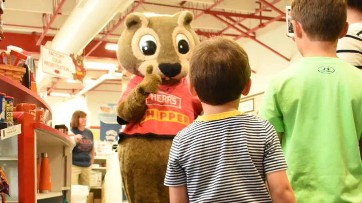 Chipper Giving A Thumbs Up To A Visiting Family